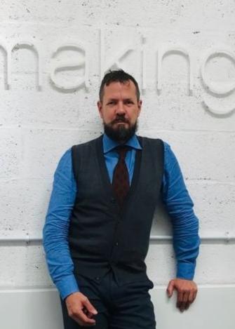 Man leaning against the eskimo heat wall