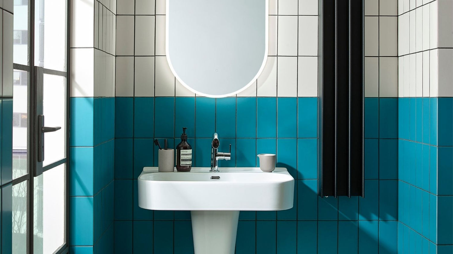 heated towel rail on a tiled wall in a small bathroom nook